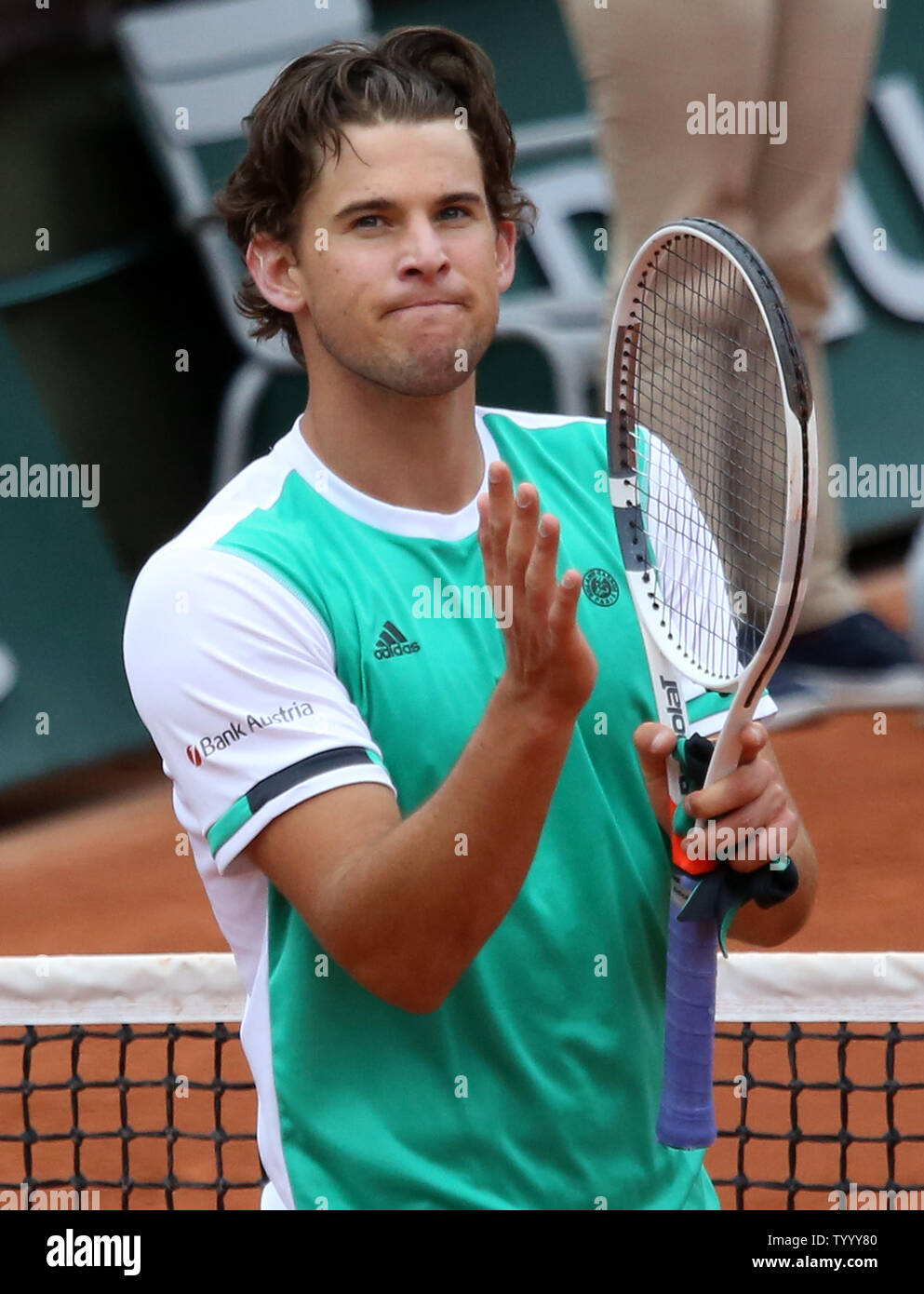 Dominic Thiem of Austria acknowledges the crowd after winning his French  Open men's quarterfinal match against Novak Djokovic of Serbia at Roland  Garros in Paris on June 7, 2017. Thiem defeated Djokovic