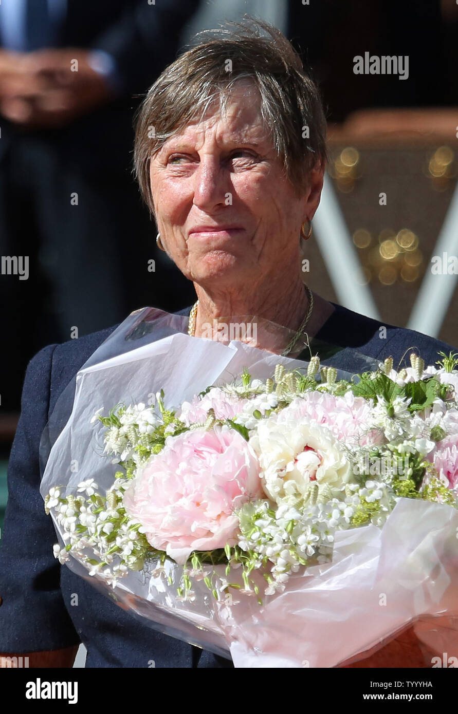 Former French tennis player Francoise Durr holds flowers after the French  Open women's final match between Simona Halep of Romania and Jelena  Ostapenko of Latvia at Roland Garros in Paris on June