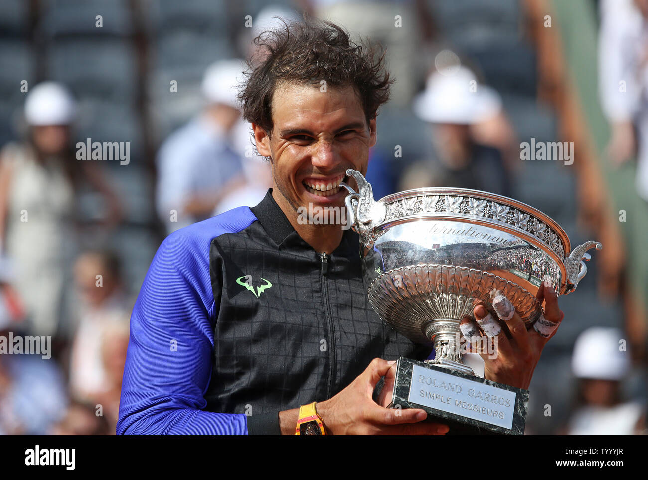 Rafael Nadal of Spain bites the championship trophy after winning his French  Open men's final match against Stan Wawrinka of Switzerland at Roland Garros  in Paris on June 11, 2017. Nadal defeated