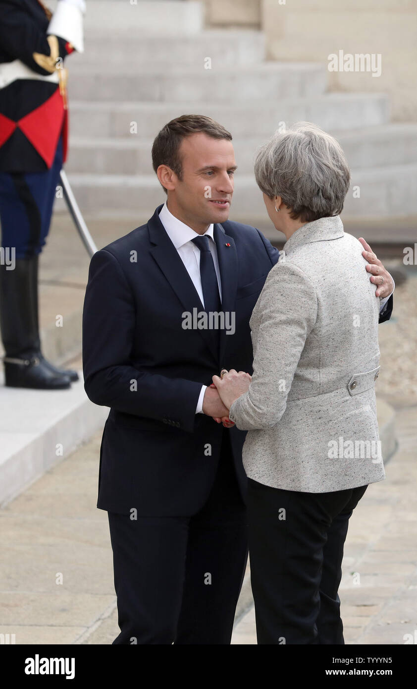 French President Emmanuel Macron (L) greets British Prime Minister Theresa May on the steps of the Elysee Palace in Paris on June 13, 2017. The two discussed said they will launch a joint campaign to tackle online radicalization. Photo by Maya Vidon-White/UPI Stock Photo