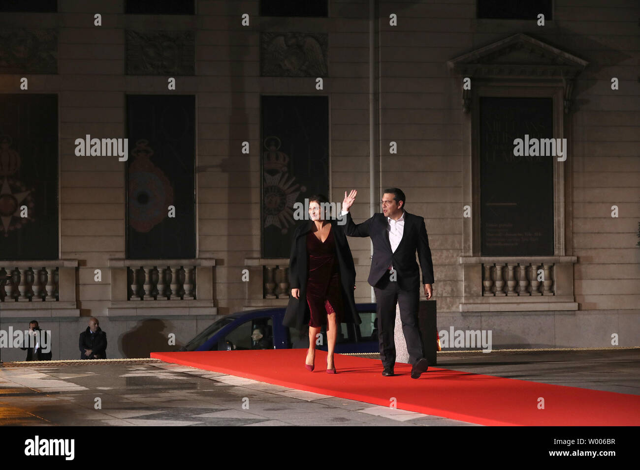 Greek Premier Alexis Tsipras (R) and his wife, Peristera Batziana, walk the  red carpet as they arrive at the Orsay Art Museum in Paris to attend a  special dinner including dozens of