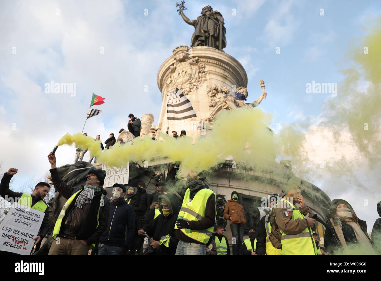 Yellow Vests demonstrators hold placards and light flares beneath the statue of Marianne, symbol of the French Republic, in Paris, February 2, 2019. The protestors took to the streets of the capital and other major French cities to denounce police violence during anti-government marches. Photo by Eco Clement/UPI Stock Photo