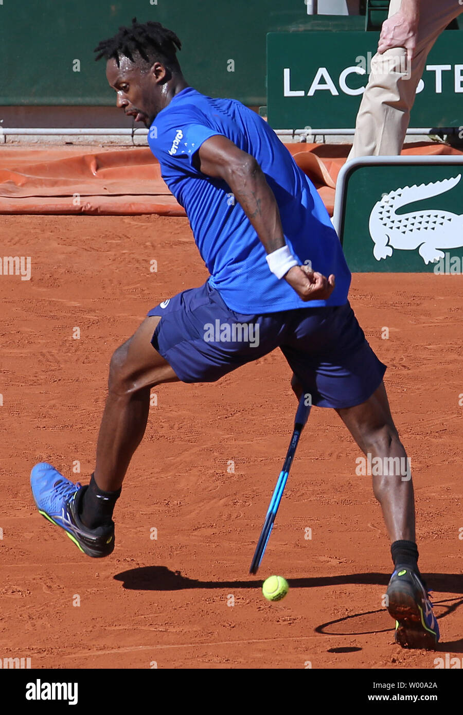 Gael Monfils of France hits a shot through his legs during his French Open  men's third round match against Antoine Hoang of France at Roland Garros in  Paris on June 1, 2019.