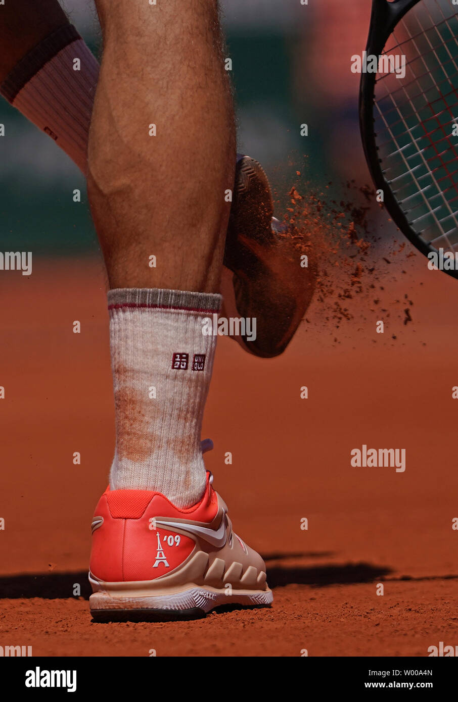 Roger Federer of Switzerland clears clay from his shoes during his French  Open men's fourth round match against Leonardo Mayer of Argentina at Roland  Garros in Paris on June 2, 2019. Federer