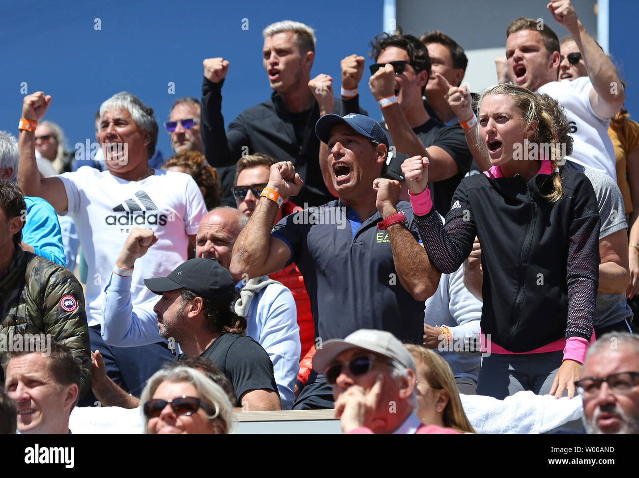 Spectators in the player's box of Dominic Thiem, including his girlfriend  Kristina 'Kiki' Mladenovic (R), react after a point during the French Open  semi-finals match between Them and Novak Djokovic of Serbia