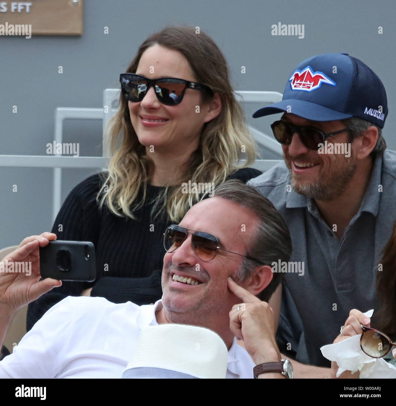 Marion Cotillard (L), Jean Dujardin (C) and Guillaume Canet watch the  French Open men's final match between Rafael Nadal of Spain and Dominic  Thiem of Austria at Roland Garros in Paris on