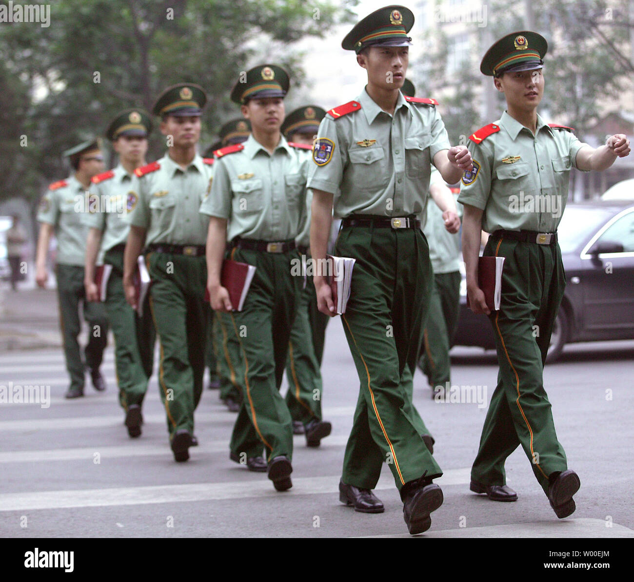 Chinese People Liberation Army (PLA) soldiers march with their books ...
