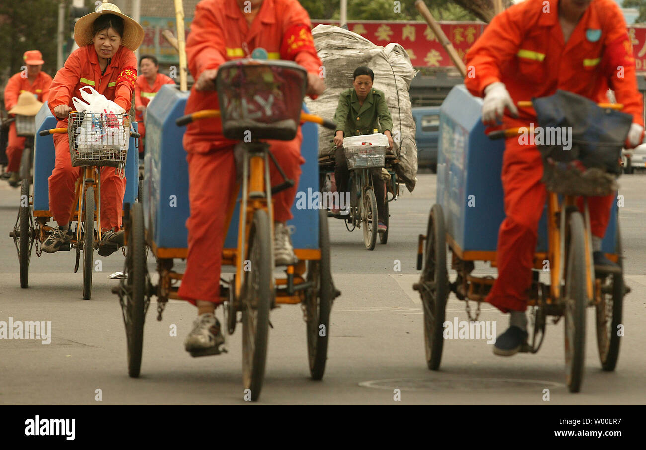 A small army of Chinese road cleaners head back to their office in central Beijing at the end of the work day on June 12, 2006. China has serious employment problems as it has a large working-age population whose average educational level is relatively low, says a white paper entitled China's Employment Situation and Policies issued in Beijing recently by the Information Office of the State Council.  (UPI Photo/Stephen Shaver) Stock Photo