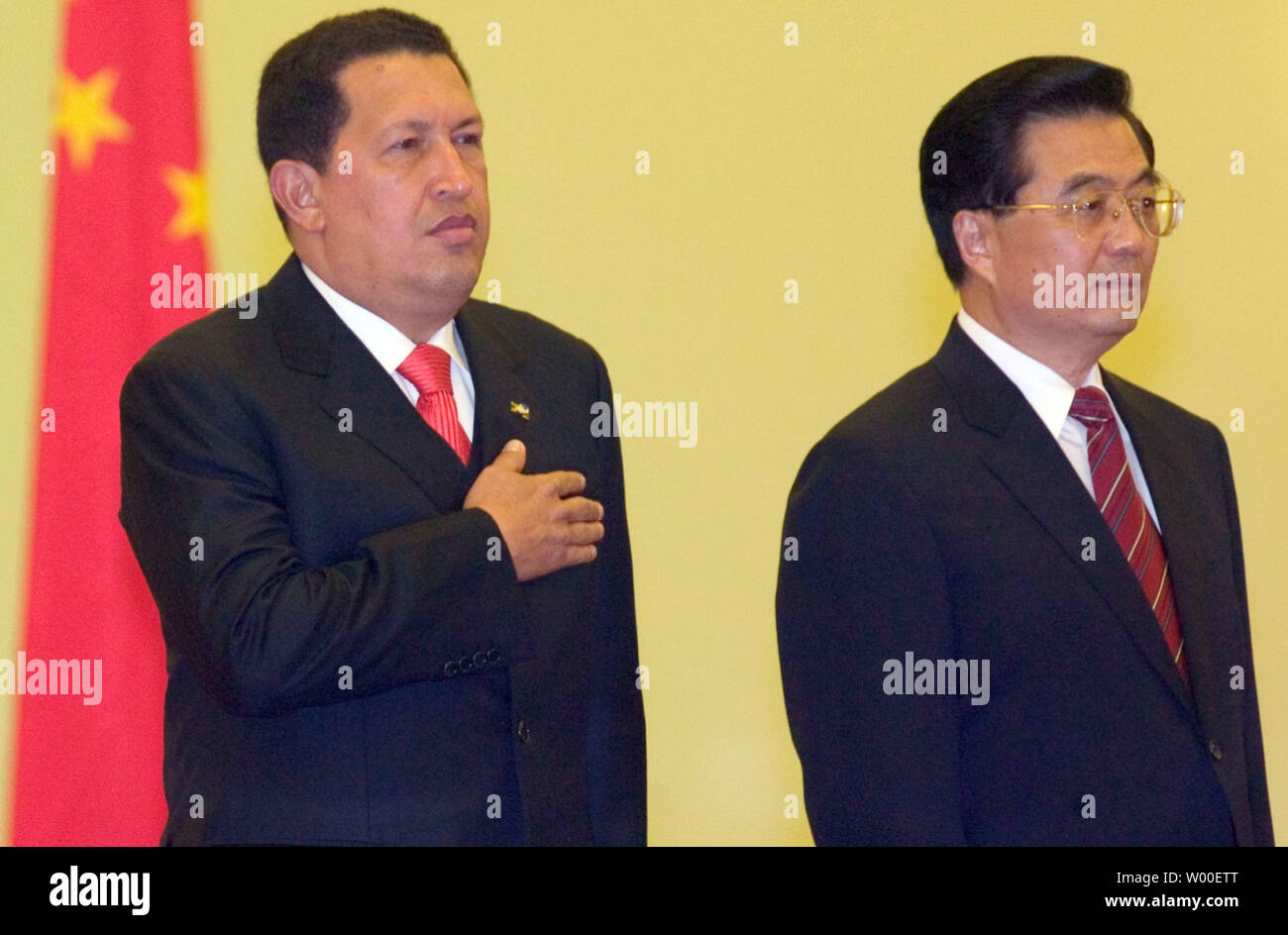 Chinese President Hu Jintao (Right) and Venezuelan President Hugo Chavez listen to the Venezuelan national anthem at a welcoming ceremony in Beijing's Great Hall of the People, August 24, 2006.   Chavez is to meet with Hu after vowing a huge increase in oil exports to China that would scale back dependence on the U.S. market.   (UPI Photo/Stephen Shaver) Stock Photo