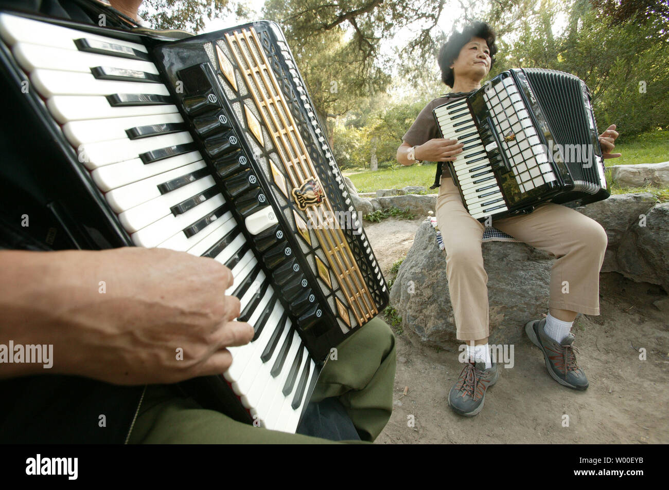 Chinese musicians practice both traditional Chinese and French compositions  for the accordion in a park in central Beijing, September 11, 2006. China's  parks, which at times unnerve local governments, serve as meeting