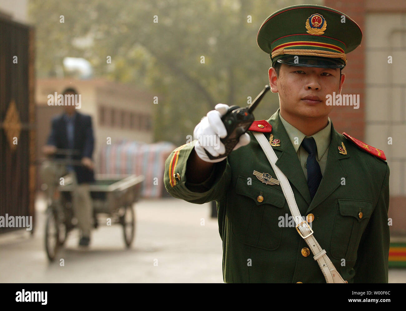 A Chinese soldier guarding the North Korean embassy in Beijing motions for people to move away from the compound on October 10, 2006.  China said on Monday it firmly opposed North Korea's nuclear test, denouncing it as 'brazen' in unusually strong language, and demanded Pyongyang stop any action that could worsen the situation. (UPI Photo/Stephen Shaver) Stock Photo