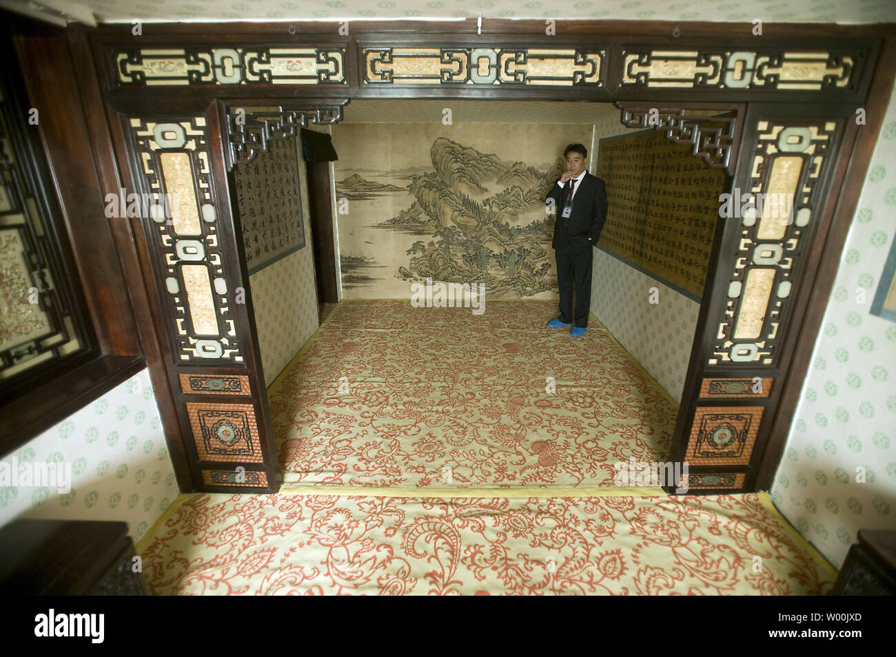 A Security Guard Patrols A Room As International And Chinese