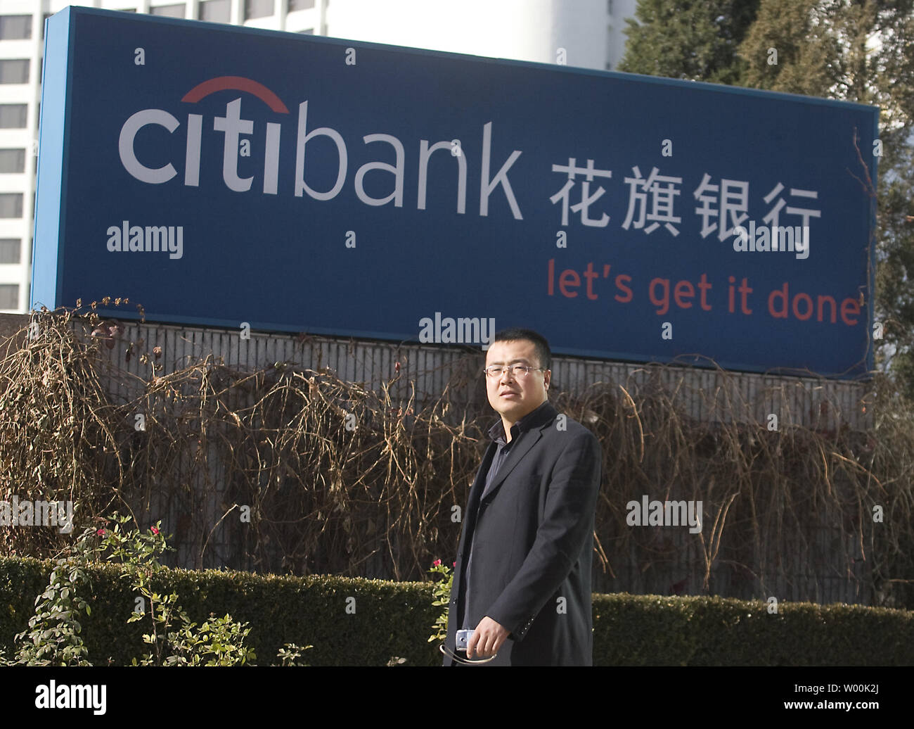 A Chinese man walks past a downtown Citibank branch in Beijing November 25, 2008.  Asia Pacific shares rose on Tuesday thanks to Wall Street's overnight rally in relief at the CitibankÕs $300bn bailout.   (UPI Photo/Stephen Shaver) Stock Photo