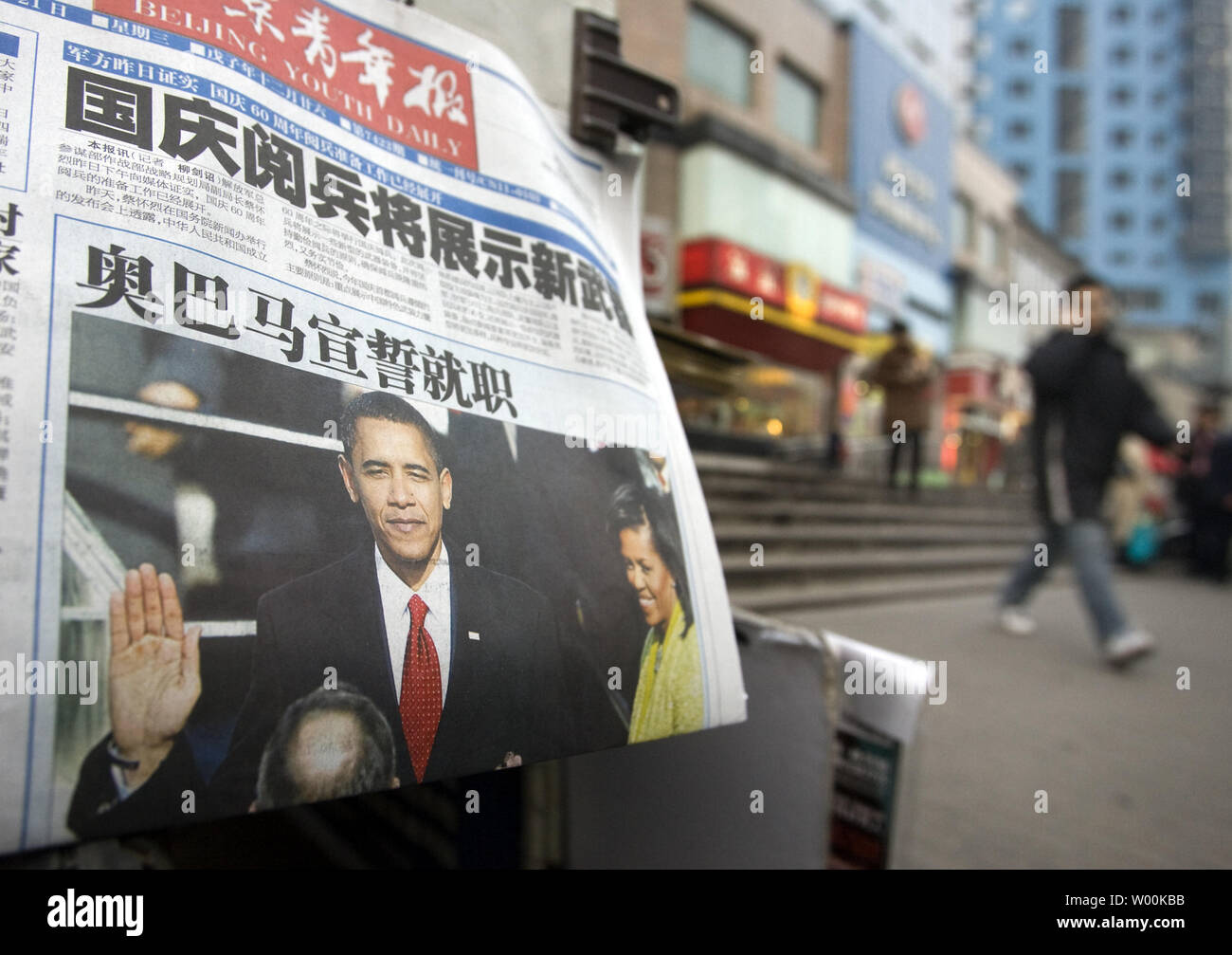 A Chinese news vendor sells newspapers featuring front-page coverage of U.S. President Barack Obama's inauguration as the 44th President of America in Beijing January 21, 2009. China offered a nervous welcome to U.S. President Barack Obama, expressing concern over the direction he may take bilateral ties while paying tribute to the efforts of George W. Bush. China censored parts of  Obama's inauguration speech on websites and state TV. (UPI Photo/Stephen Shaver) Stock Photo
