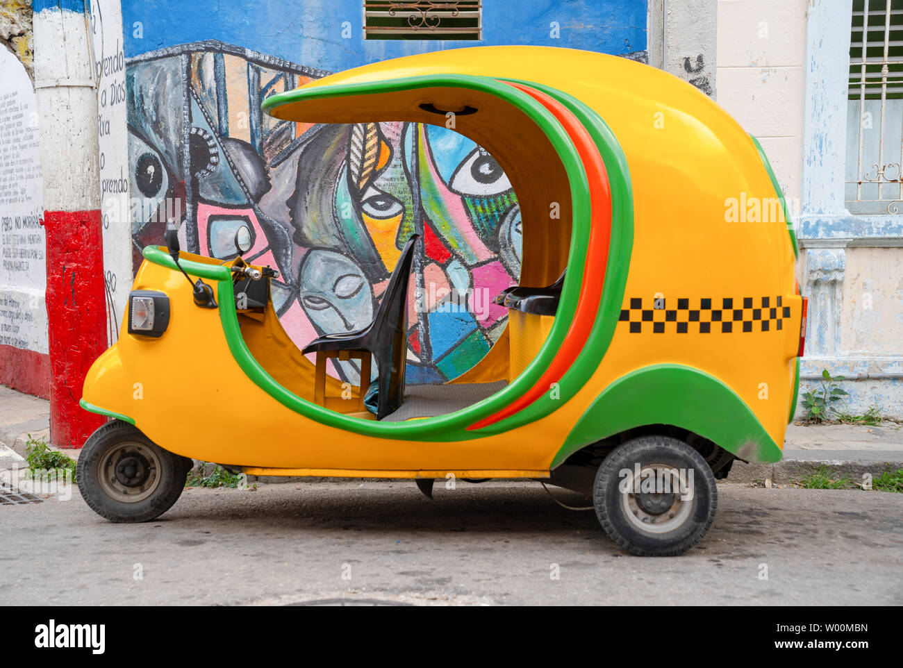 A Yellow Coco Taxi Parked in Havana, Cuba, Stock Photo