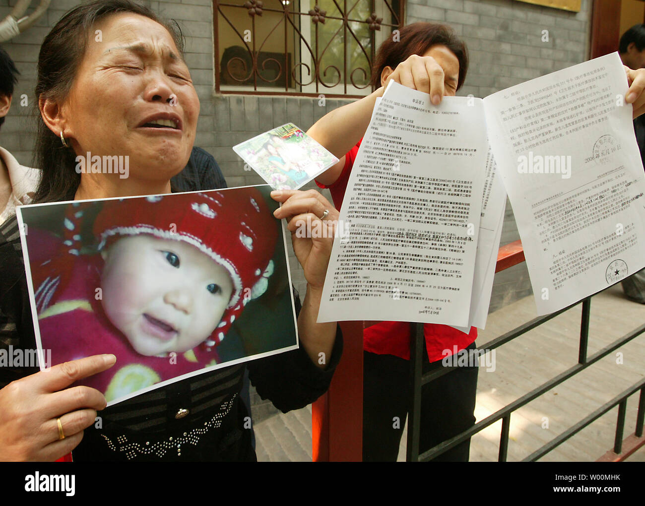 Chinese families whose children died as a result of drinking milk contaminated with melamine protest in front of a government building in Beijing on May 8, 2009. China says a total of 296,000 children had fallen ill from consuming milk products tainted with melamine. Reports reveal that 213 families whose children were made ill or died from tainted milk have petitioned the Supreme Court, demanding higher levels of compensation.   (UPI Photo/Stephen Shaver) Stock Photo