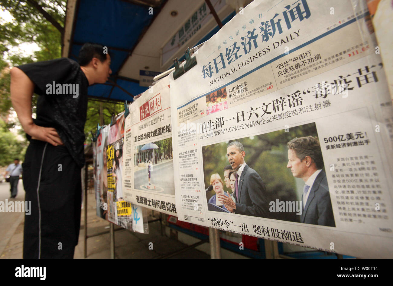 A Chinese man looks at the latest magazines and newspapers on sale at a news kiosk, featuring a government newspaper with a front page article on U.S. President Barack Obama, in Beijing, September 9, 2010.    UPI/Stephen Shaver Stock Photo