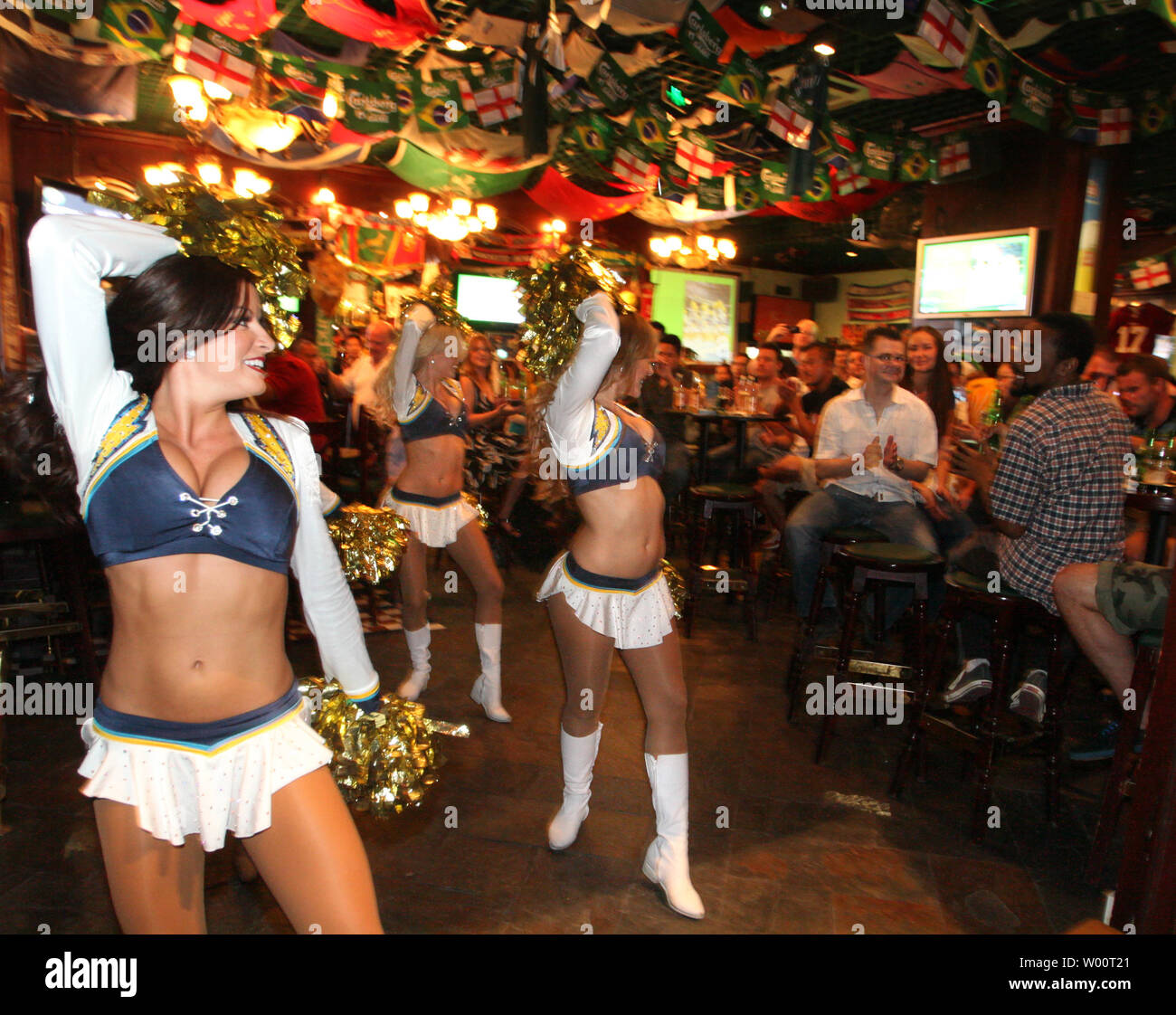San Diego Chargers cheerleaders perform dance routines in an Irish sports bar, marking the opening of the National Football League's (NFL) 2010 season, in Beijing, September 12, 2010.  NFL live broadcasts will hit Chinese screens for the fourth consecutive year when the new season kicks off.  For Chinese sports fans, there is an extra reason to watch the NFL, as Ed Wang, the Buffalo Bills' rookie offensive tackle, became the first player with direct Chinese ancestry to be selected in the NFL draft.   UPI/Stephen Shaver Stock Photo