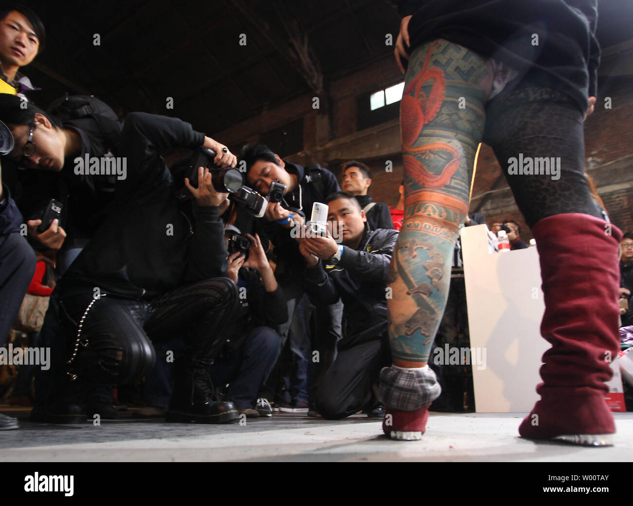 A heavily tattooed Chinese woman poses for photographers during the Beijing International Tattoo Convention being held in Beijing's 798 Art zone October 17, 2010.     UPI/Stephen Shaver Stock Photo