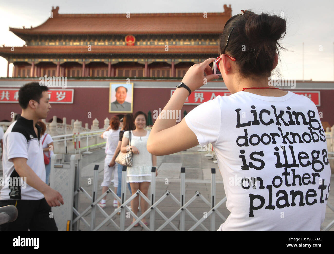 A Chinese tourist takes a photograph of Tiananmen Square's north rostrum, featuring a giant portrait of former helmsman Mao Zedong, in central Beijing on June 3, 2011.  China's capital is under heavy security in the lead up to the June 4 anniversary of the 1989 government crackdown on pro-democracy protests, which killed thousands of unarmed students.      UPI/Stephen Shaver Stock Photo