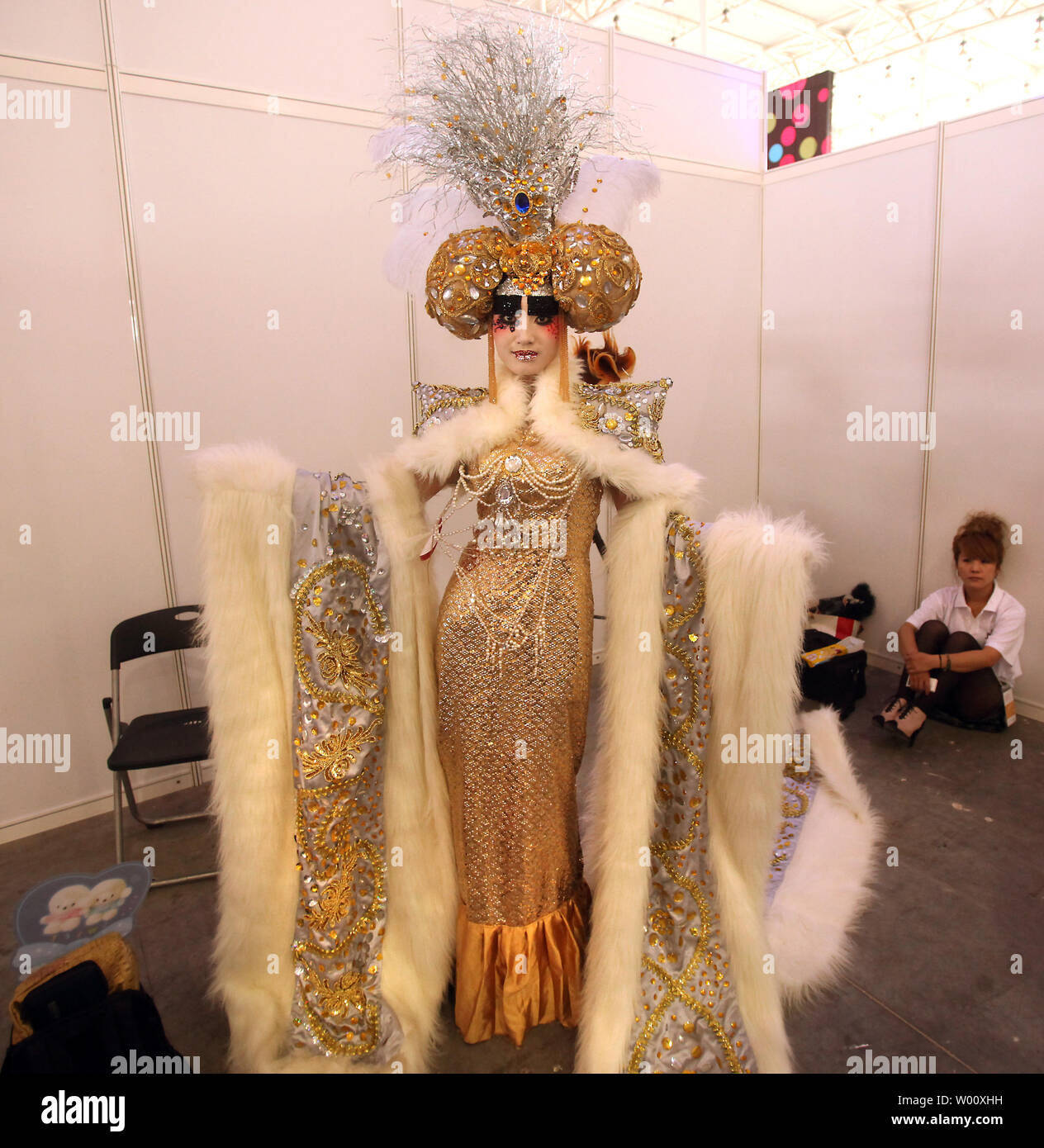 Chinese models dressed in fancy wedding gowns and adorned with costume  jewelry attend the 2011 China Hair and Beauty Expo in Beijing on June 29,  2011. The models, along with their sponsors,