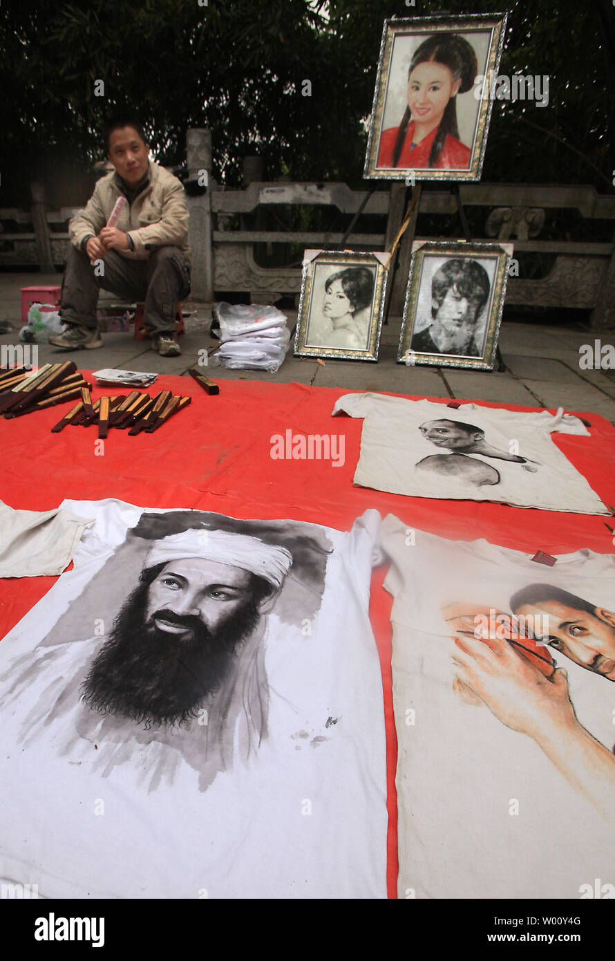 A Chinese artists displays examples of his work, including a charcoal portrait of recently killed al Qaeda leader Osama bin Laden in Beijing on October 5, 2011.  China officially criticized U.S. Barack Obama's administration for the military operation that led to the killing of bin Laden.       UPI/Stephen Shaver Stock Photo