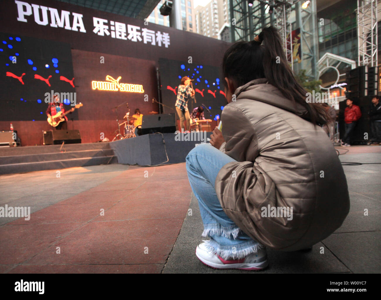 A Chinese rock band hired by Puma, a leading sports lifestyle company,  plays American music covers during a public marketing event at an  international fashion mall in Beijing November 5, 2011. Foreign