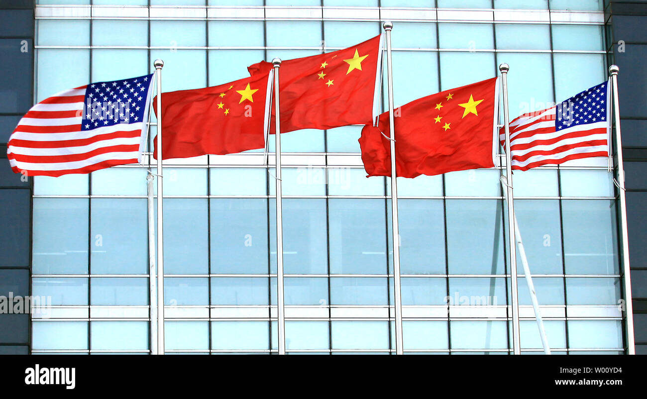 Both the American and Chinese national flags fly in front of a new international finance center in downtown Beijing November 23, 2011.   The United States this week hailed key trade talks  with China as a success, saying they had made "meaningful, concrete progress" on piracy and market access, but warned more work needed to be done.      UPI/Stephen Shaver Stock Photo