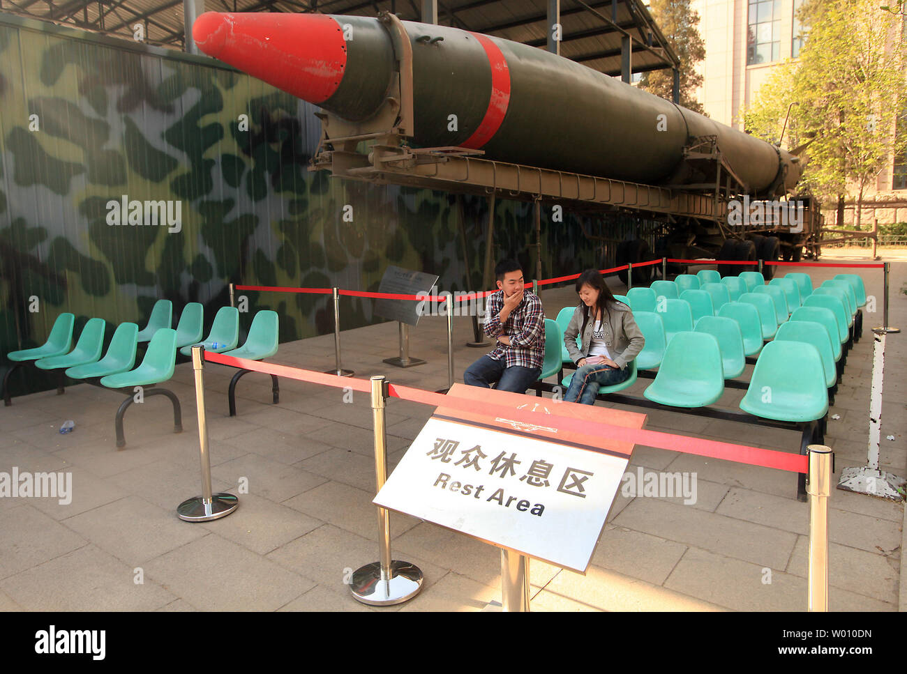Chinese tourists relax near a Dongfeng 1, a copy of the Soviet R-2 (SS-2), on display at China's National Military Museum, meant to showcase the country's military might, in Beijing April 15, 2012.  The United States has underestimated the growth of China's military as American policymakers have taken official statements at face value or failed to understand Beijing's thinking, according to a recent study by a security commission.   UPI/Stephen Shaver Stock Photo