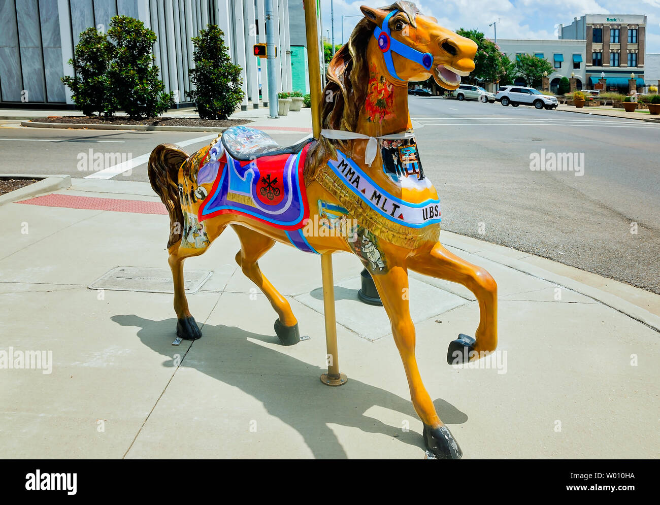 A carousel horse stands in downtown Meridian, Mississippi on June 23, 2019. The statue is one of 62 horses distributed throughout town. Stock Photo