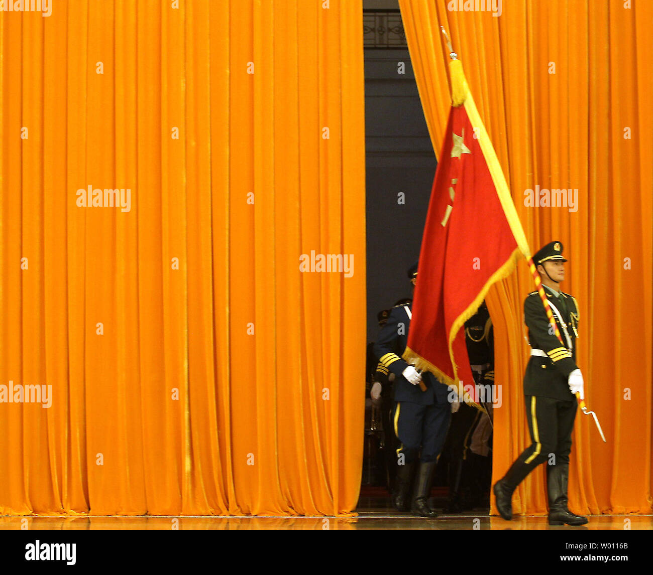 Chinese soldiers performing honor guard duties emerge from behind a large curtain in Beijing on June 7, 2012.      UPI/Stephen Shaver Stock Photo