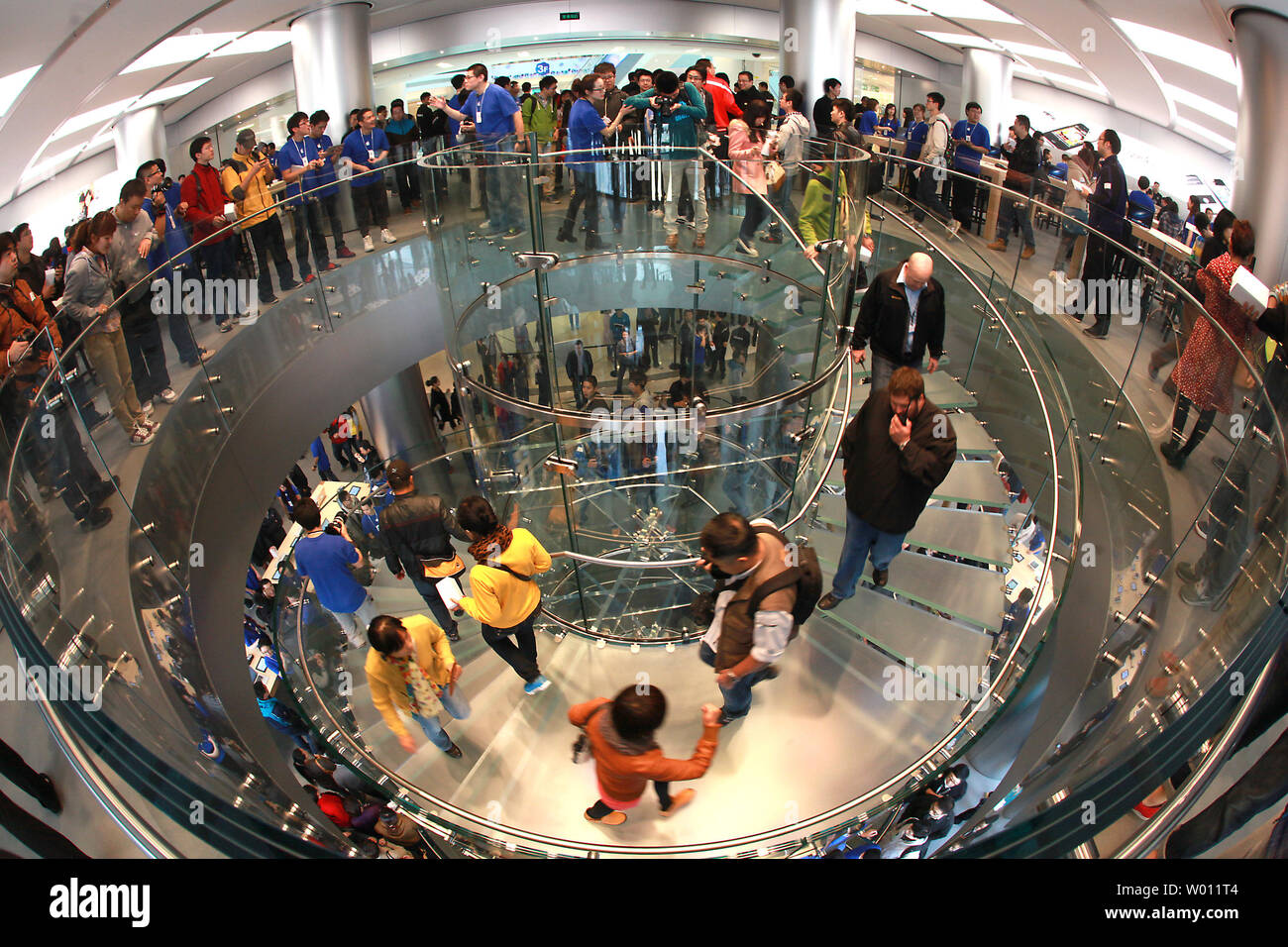 Chinese visit China's newest (sixth) and Asia's largest Apple store, a sprawling 3-floor complex, opening in central Beijing, not far from Tiananmen Square, on October 20, 2012.  Apple's iPhones, iPads and computers are very popular with Chinese, but with only five authorized stores in the country copy cats have sprung up to meet the demand.    China is now the second-biggest market for Apple after the United States, but the company has also faced frequent criticism for the working conditions in which its products are produced in China.    UPI/Stephen Shaver Stock Photo