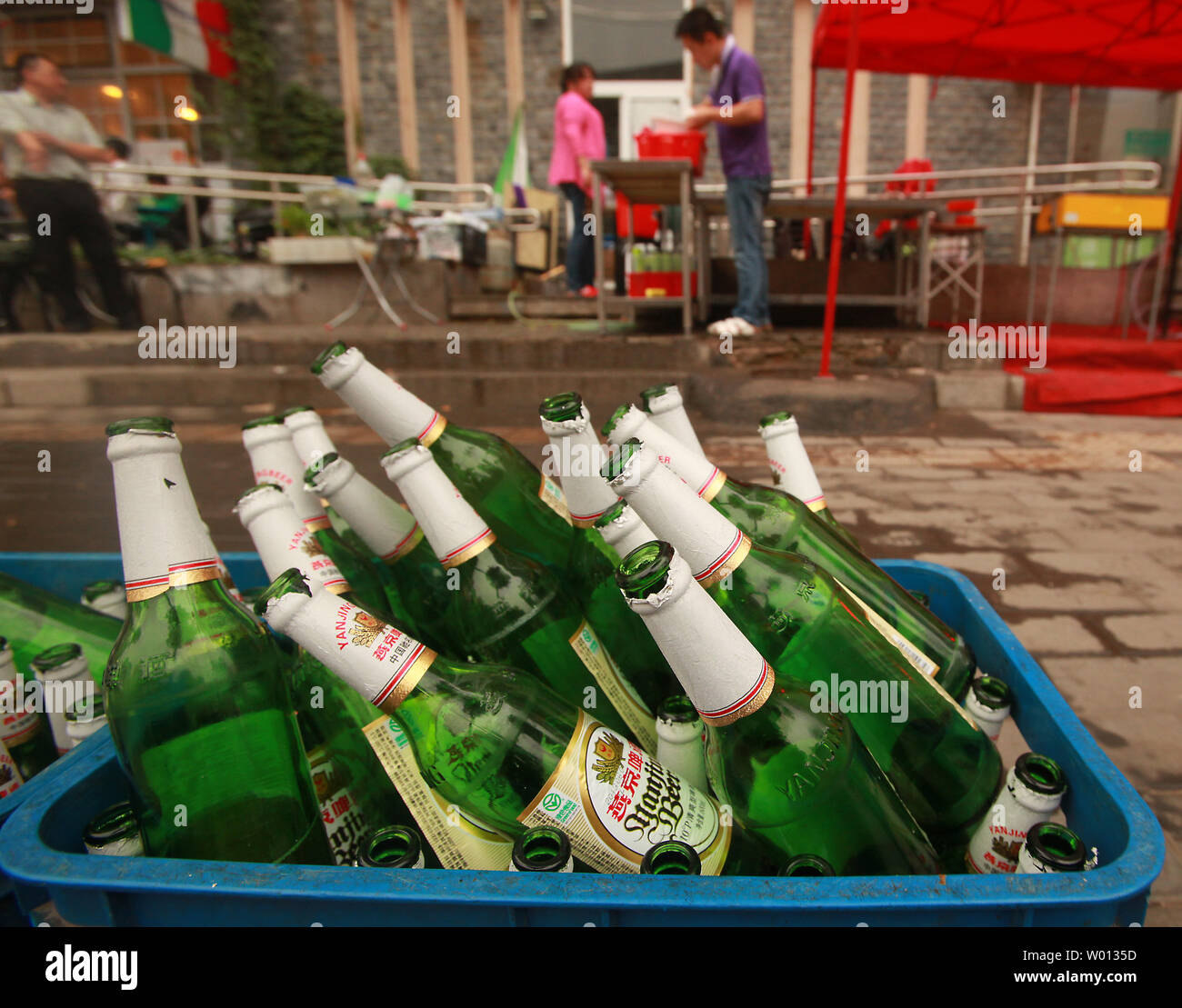Empty bottles of beer are placed on a curb outside a restaurant  in Beijing on June 7, 2013.  Global alcohol consumption continued to climb in 2012 and 2013 with China remaining the world's top market as well as the fastest-growing imbibing nation, according to a recent international report.      UPI/Stephen Shaver Stock Photo