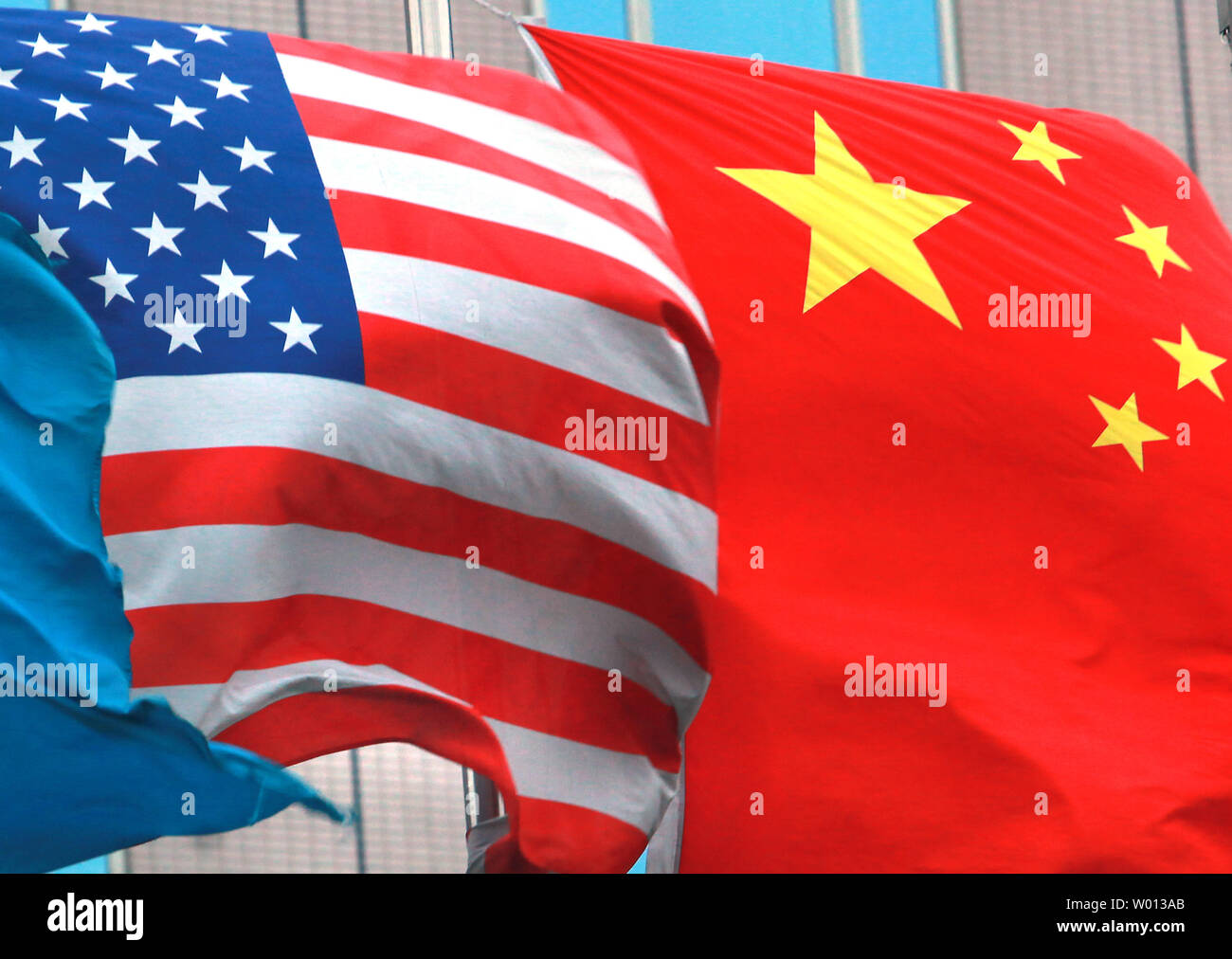 Both American and Chinese national flags fly next to each other outside an international hotel in Beijing on July 7, 2013. Even after months of tensions over alleged cyberattacks and continual trade disputes, the leaders of China and the United States have struck positive tones recently as both agreed on forging a "new model" for their relations going forward. UPI/Stephen Shaver Stock Photo