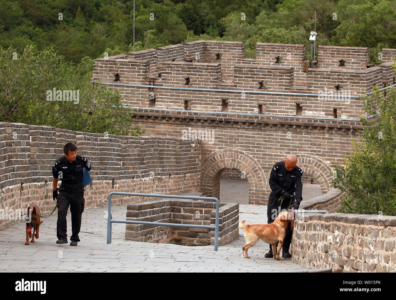 Police with bomb-sniffing canines sweep the area where U.S. Secretary of State John Kerry will visit the Badaling section of the Great Wall of China just outside of Beijing on July 8, 2014.  Kerry is in China's capital to participate in the sixth round of the U.S.-China Strategic  and Economic Dialogue known as the 'S&ED.'   UPI/Stephen Shaver Stock Photo