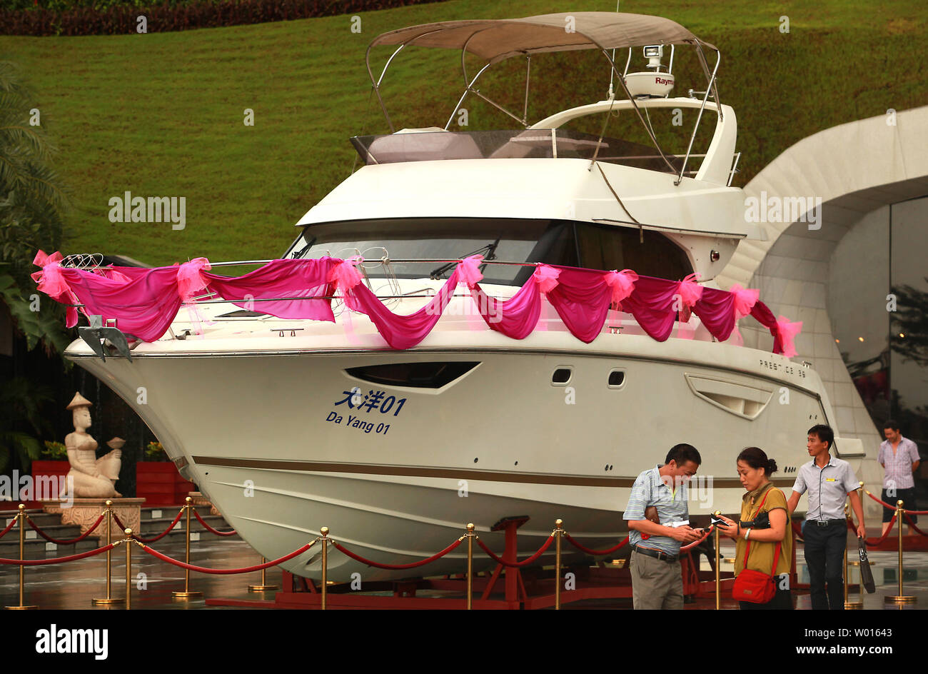A new, Chinese-made yacht is displayed outside an upscale housing estate in hopes of attracting rich buyers in Beijing on September 14, 2014.  China created 40,000 new millionaires last year, bringing the total to 1.09 million, despite a corruption crackdown and austerity program launched by the government.       UPI/Stephen Shaver Stock Photo