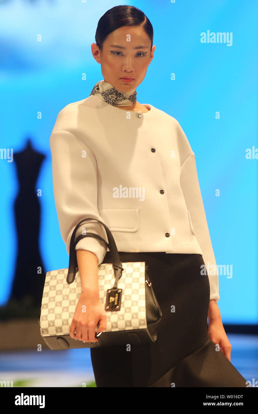 Chinese models wear clothing from the 2015 White Collar Collection during the annual China Fashion Week in Beijing on November 2, 2014.  Over 70 domestic and international fashion brands will showcase their new collections in what has become an internationally recognized platform for new designers.       UPI/Stephen Shaver Stock Photo