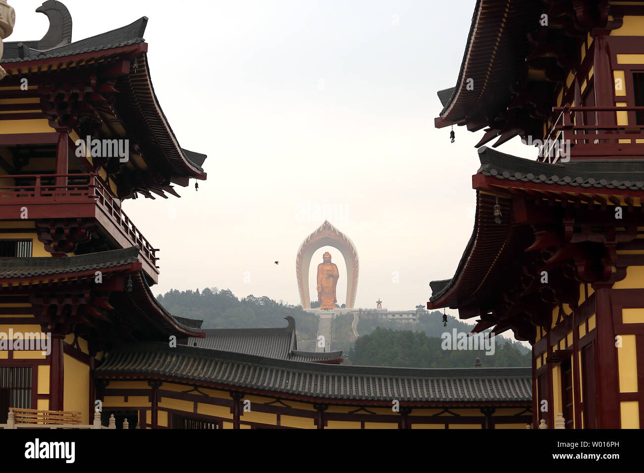 Chinese tourists visit the Donglin Buddha, located in the foothills of Lushan Mountain in east China's Jiangxi Province, on November 19, 2014.  The Buddha statue is  the world's highest Amitabha statue, according to the government.  China has slowly, but positively embraced ecotourism as unchecked development across the country has begun threatening cultural heritage areas and the traditional ways of life in ethnic-rich provinces.     UPI/Stephen Shaver Stock Photo
