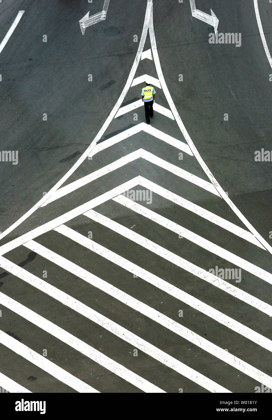 A Chinese policeman directs traffic in Dandong, China's largest border city with North Korea, in Liaoning Province, on May 30, 2015.  China remains North Korea's most important ally, providing Pyongyang with most of its food and energy supplies and comprises over sixty percent of its total trade volume.  North Korea's economic dependence on China continues to grow due to international sanctions, as indicated by the significant trade imbalance between the two countries.     Photo by Stephen Shaver/UPI Stock Photo