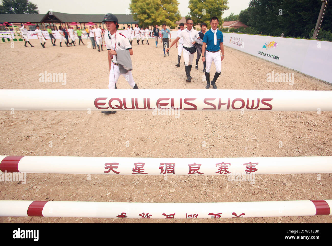 Chinese jockeys count off steps between jumps during the First China Show Jumping Open at the Equuleus International Riding Club in Beijing on August 16, 2015.  China's wealth gap has widened to a level where it is among the world's most unequal nations, according to a Chinese academic, as huge numbers of poor are left behind by the economic boom.  The country's  growing wealth gap is a major concern for Communist authorities, who are keen to avoid public discontent that could lead to social unrest in the country of 1.3 billion people.      Photo by Stephen Shaver/UPI Stock Photo