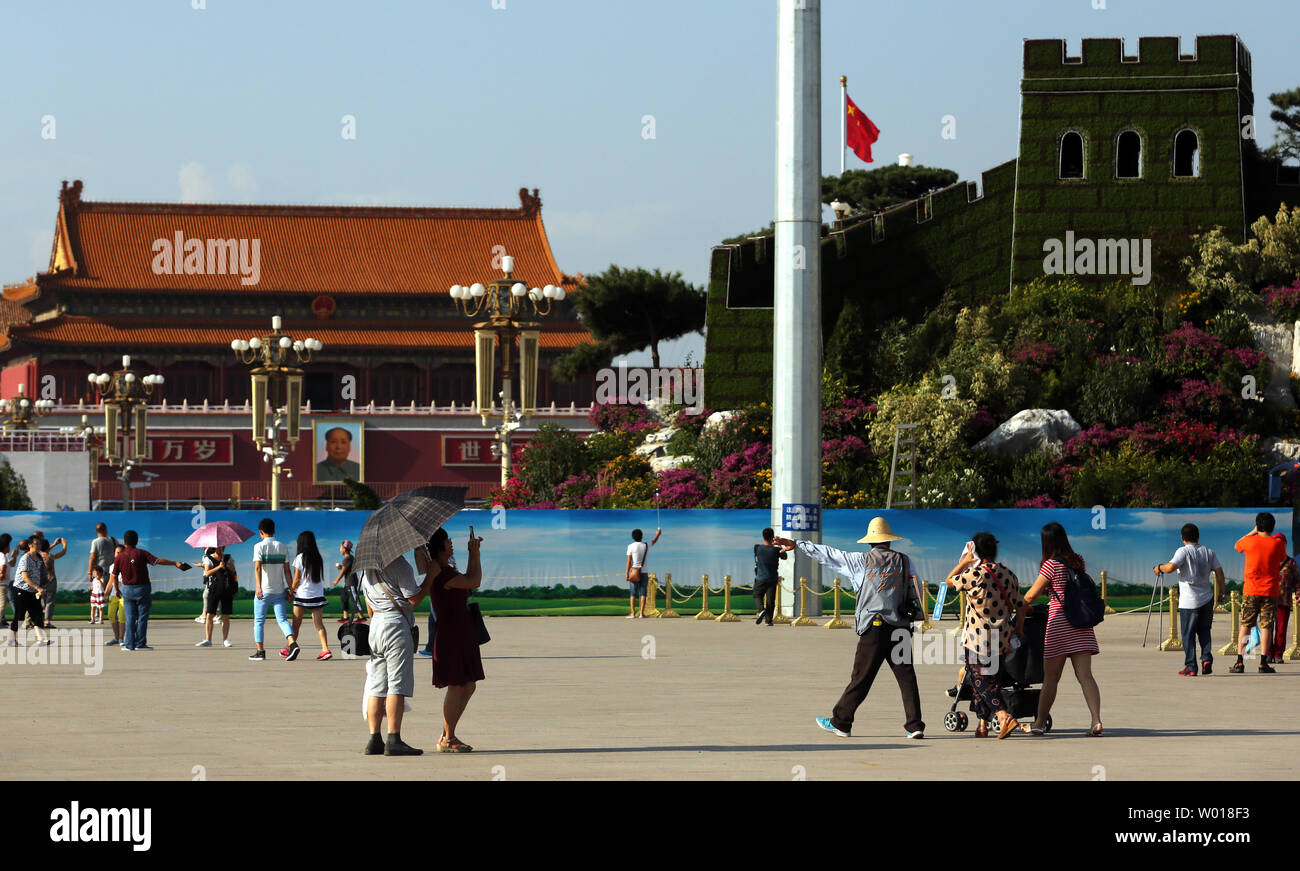 Chinese tourists visit Tiananmen Square, which is being decorated for the upcoming military parade commemorating the end of World War Two, in Beijing on August 20, 2015.  China will showcase its military might with a massive military parade next month as the country takes a three-day holiday to commemorate the defeat of Japan in 1945.     Photo by Stephen Shaver/UPI Stock Photo