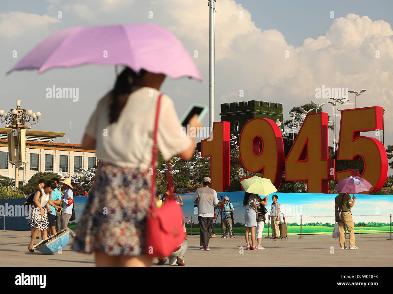 Chinese tourists visit Tiananmen Square, which is being decorated for the upcoming military parade commemorating the end of World War Two, in Beijing on August 20, 2015.  China will showcase its military might with a massive military parade next month as the country takes a three-day holiday to commemorate the defeat of Japan in 1945.     Photo by Stephen Shaver/UPI Stock Photo
