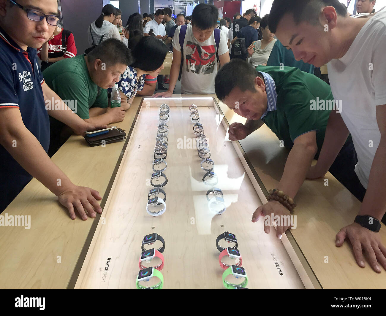 Chinese look at the new Apple Watch at the company's flagship store in downtown Beijing on August 25, 2015.  With Apple shares plunging on concerns that its strong growth in China will suffer from a slowing economy, Chief Executive Tim Cook took the unusual step of reassuring jittery shareholders that its business in China is doing just fine.     Photo by Stephen Shaver/UPI Stock Photo