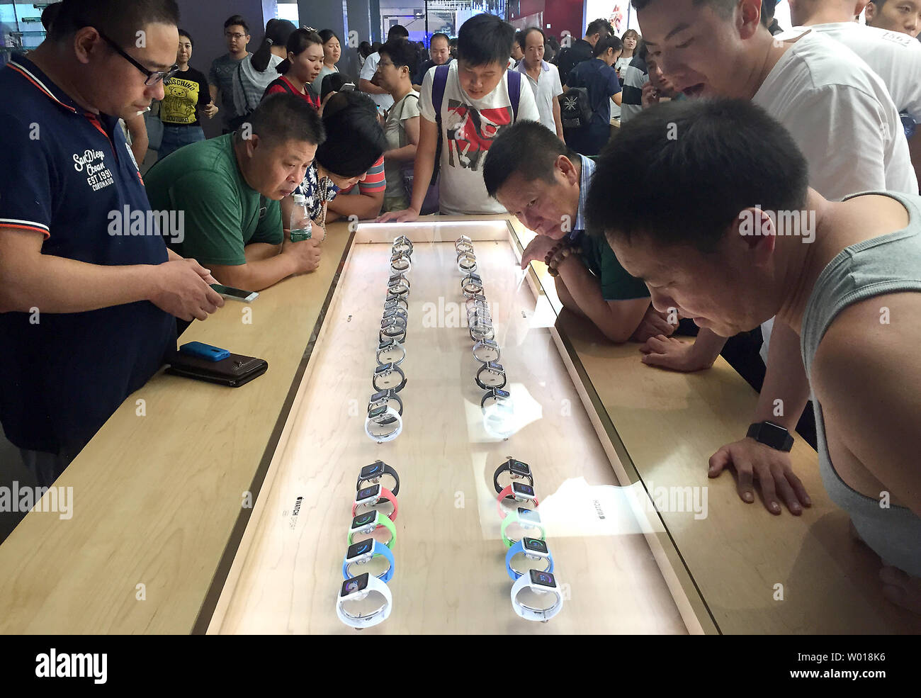 Chinese look at the new Apple Watch at the company's flagship store in downtown Beijing on August 25, 2015.  With Apple shares plunging on concerns that its strong growth in China will suffer from a slowing economy, Chief Executive Tim Cook took the unusual step of reassuring jittery shareholders that its business in China is doing just fine.     Photo by Stephen Shaver/UPI Stock Photo