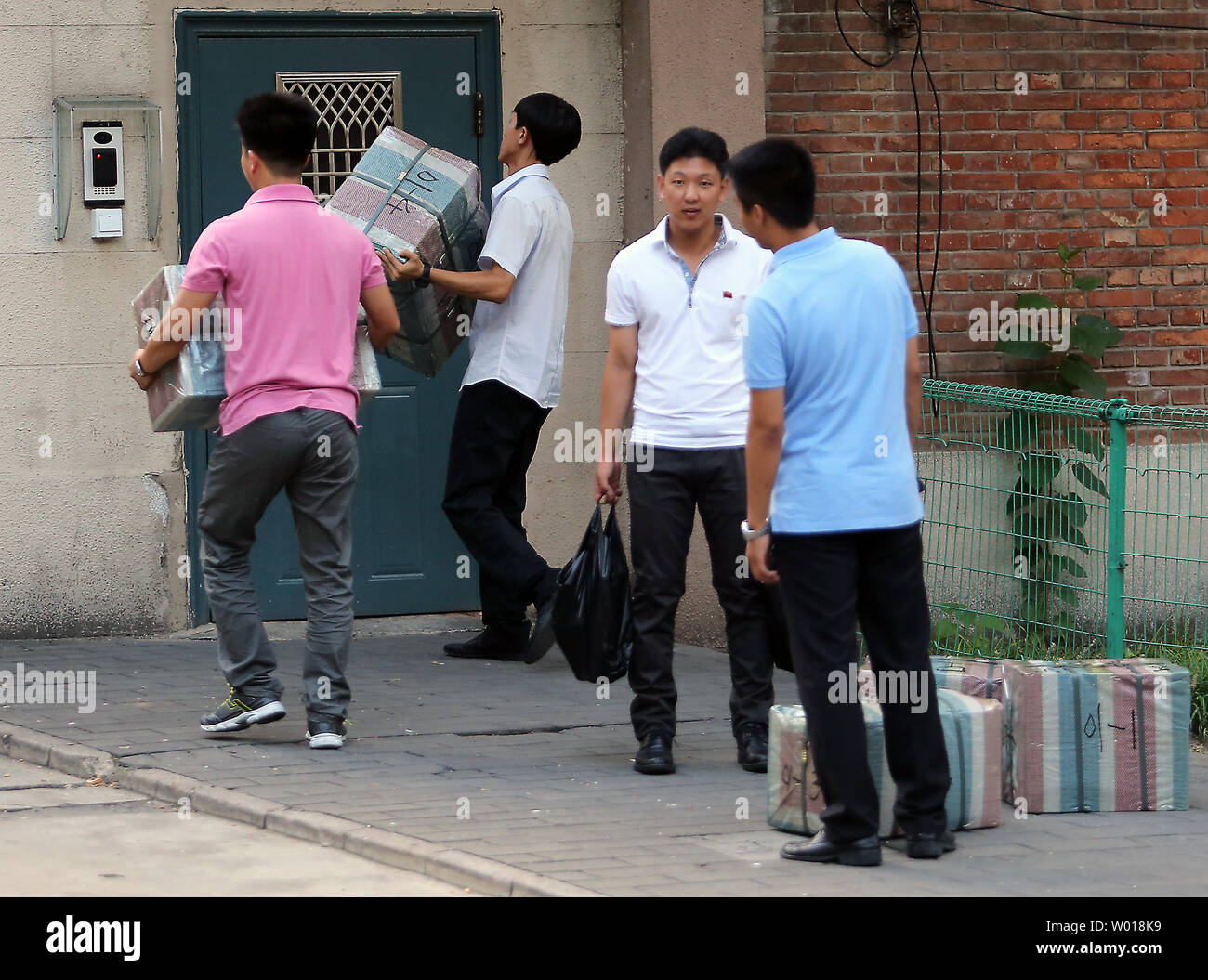 North Koreans carry packages into their embassy in Beijing on August 26, 2015.  Despite China being North Korea's lifeline regarding energy, food and international diplomacy, North Korean leader Kim Jong Un declined an invitation to a attend a military parade commemorating China's victory over Japan during World War II.  The snub was announced amid escalating military tensions between North and South Korea.    Photo by Stephen Shaver/UPI Stock Photo