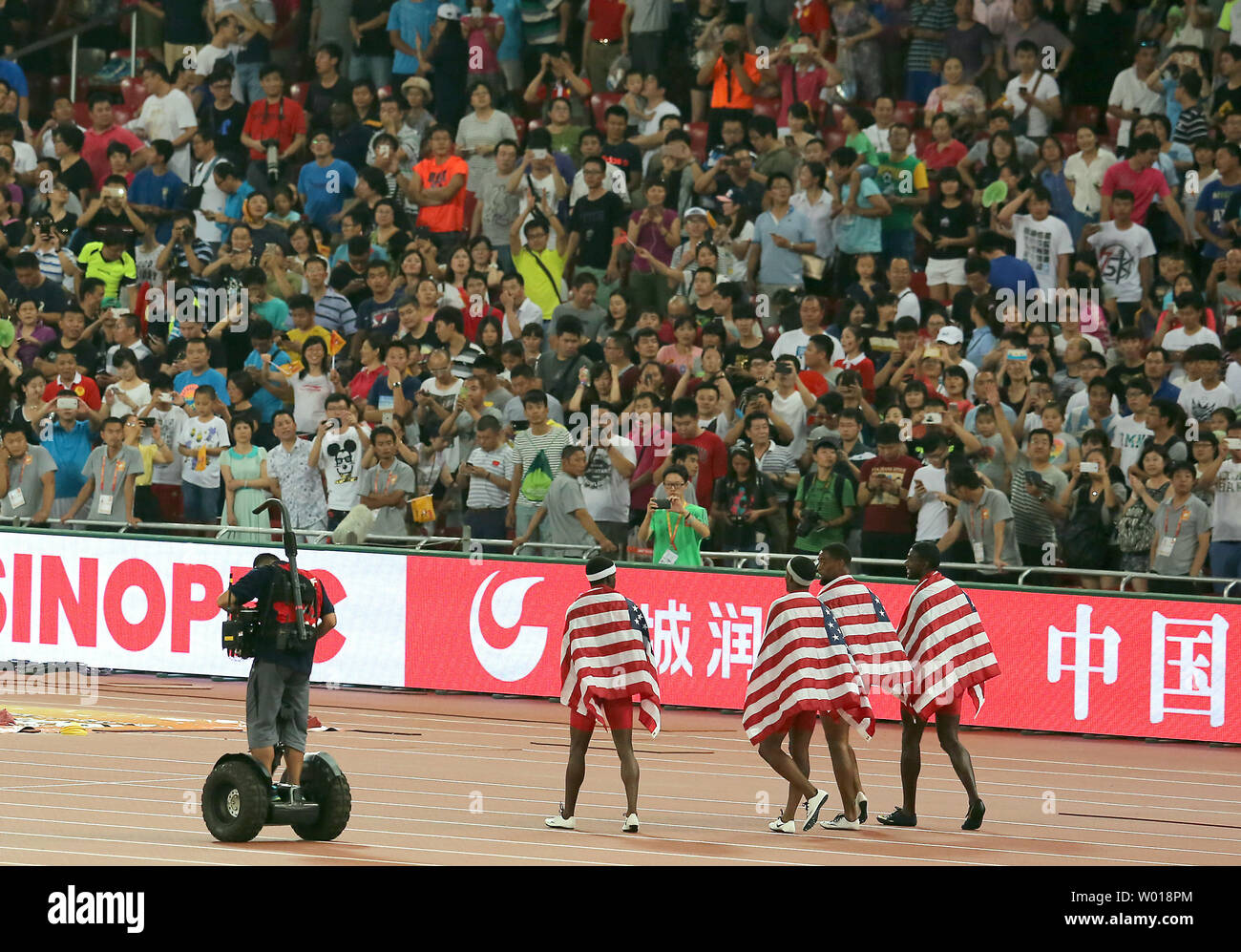 Team USA walks around the stadium after being disqualified in the 4x100 meters relay final at the IAAF World Championships being hosted by Beijing on August 29, 2015.  Jamaica won with a time of 37.36 seconds, followed by China (38.01) and Canada (38.13) in third.     Photo by Stephen Shaver/UPI Stock Photo