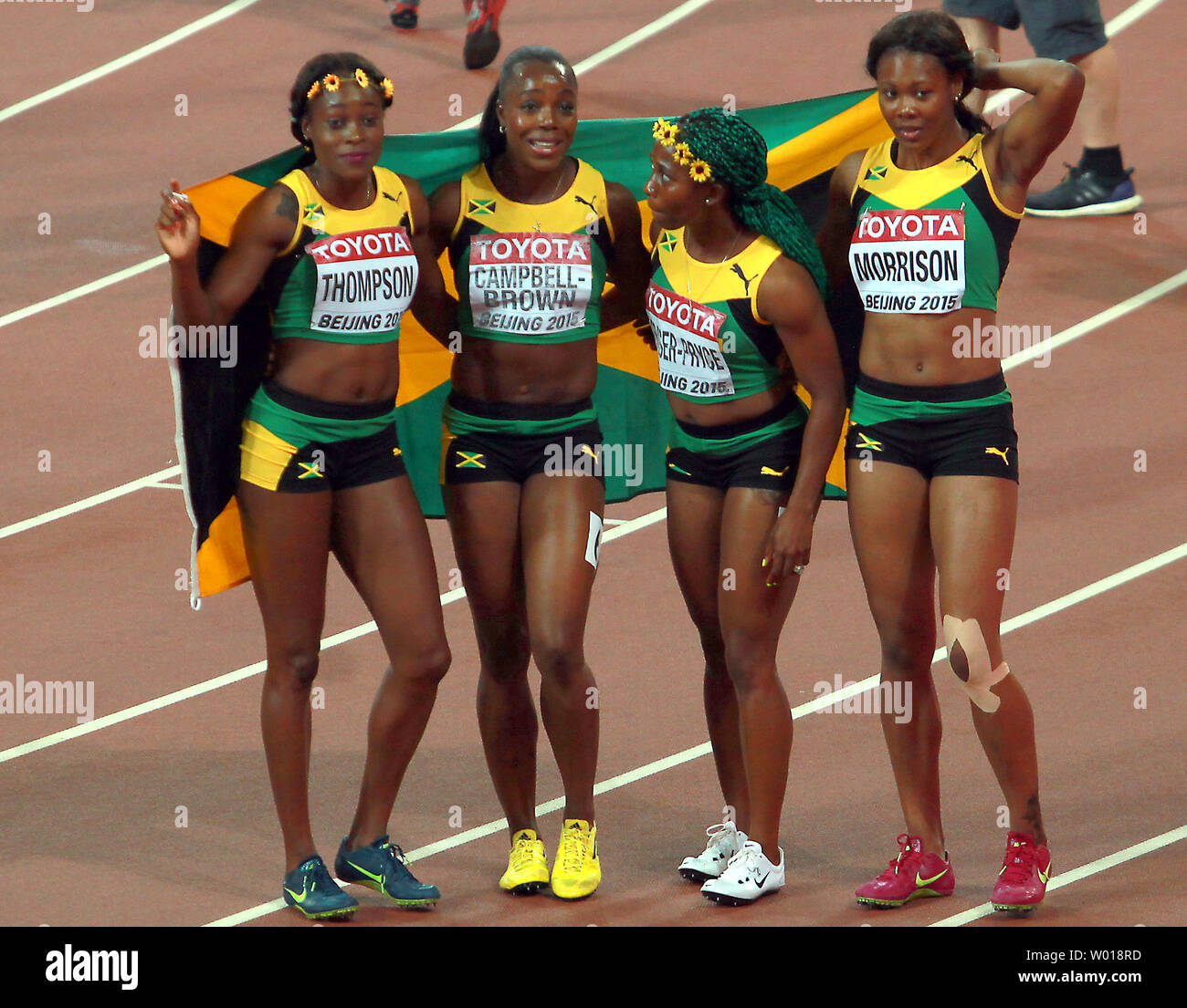 (L-R) Jamaica's Elaine Thompson, Veronica Brown, Shelly-Ann Fraser-Pryce and Natasha Morrison pose with the Jamaican flag after winning the 4x100 meters women's relay final at the IAAF World Championships being hosted by Beijing on August 29, 2015.  Jamaica won with a time of 41.07 seconds, followed by USA (41.68) and Trinidad and Tobago (42.03) in third.     Photo by Stephen Shaver/UPI Stock Photo