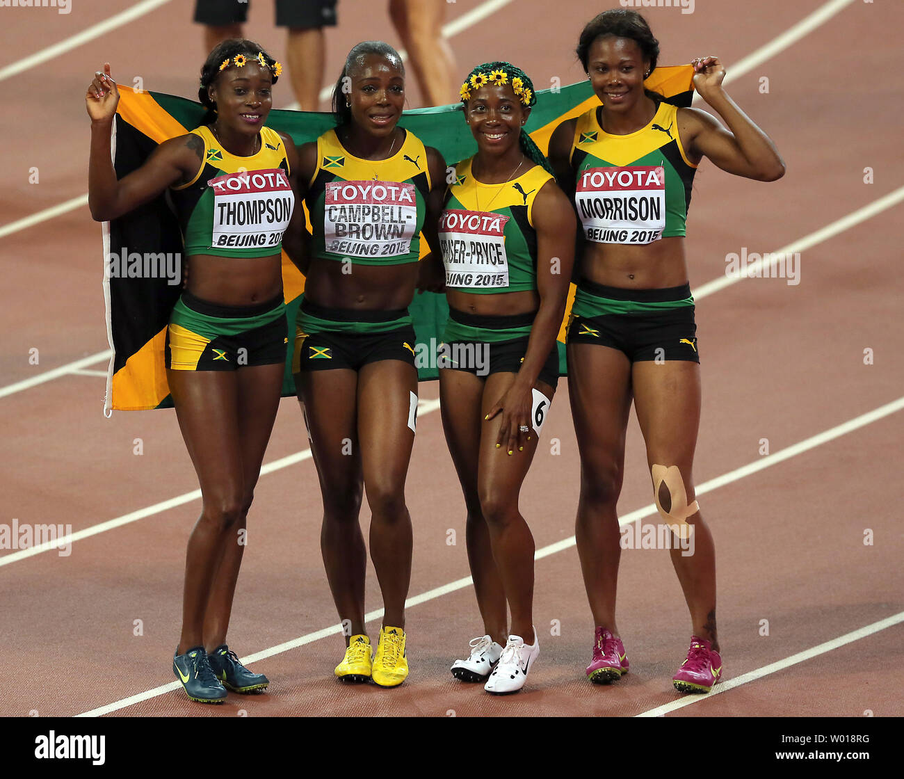 (L-R) Jamaica's Elaine Thompson, Veronica Brown, Shelly-Ann Fraser-Pryce and Natasha Morrison pose with the Jamaican flag after winning the 4x100 meters women's relay final at the IAAF World Championships being hosted by Beijing on August 29, 2015.  Jamaica won with a time of 41.07 seconds, followed by USA (41.68) and Trinidad and Tobago (42.03) in third.     Photo by Stephen Shaver/UPI Stock Photo