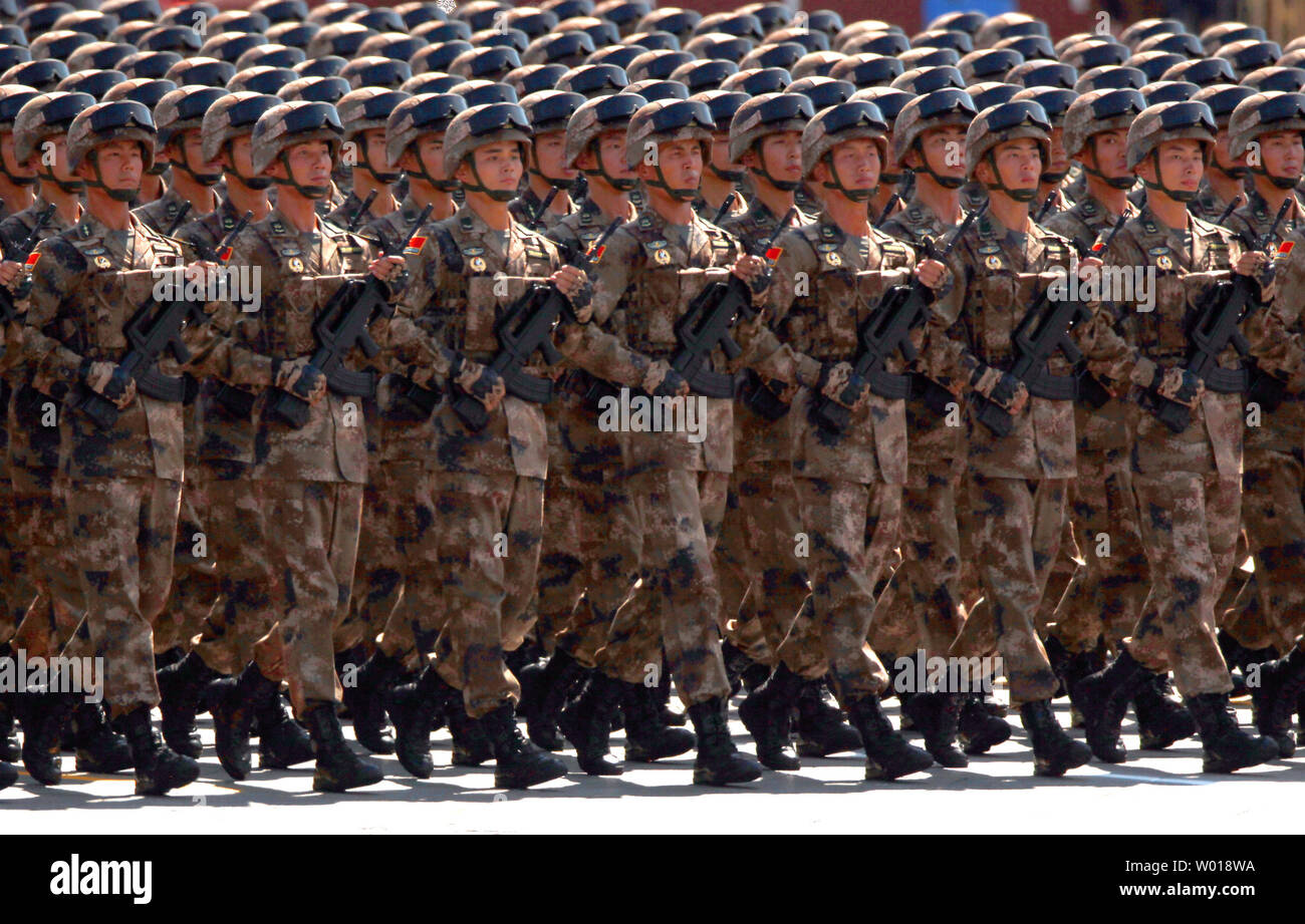 Over 12,000 soldiers and hundreds of tanks, ballistic missile launchers, amphibious assault vehicles, drones, fighter jets, helicopters and other military equipment participate in a massive parade marking the 70th anniversary of victory over Japan and the end of World War II in Beijing on September 3, 2015.  Presiding over the extravaganza, President Xi Jinping, China's most powerful leader in decades, said that China would remain committed to 'the path of peaceful development' and unexpectedly vowed to cut 300,000 troops from its 2.3-million strong military -  the world's largest.       Photo Stock Photo