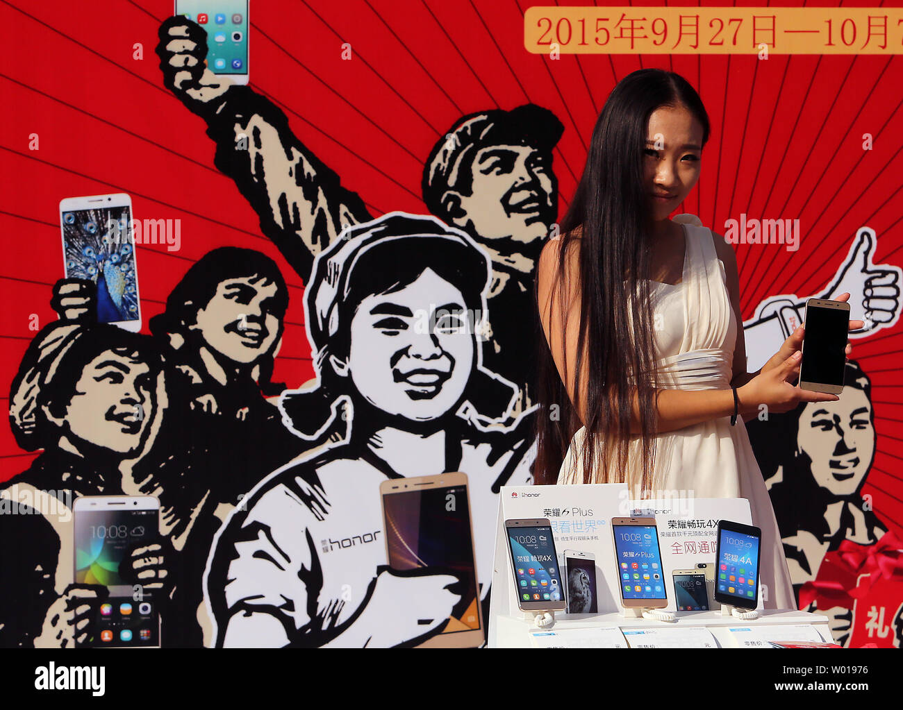 Chinese models promote various smartphones and laptops outside an electronics center notorious for selling fake, grey market and pirated electronics in Beijing on September 27, 2015.  The theft of intellectual property rights and corporate secrets from U.S. companies by China remains a major issue between the two countries.     Photo by Stephen Shaver/UPI Stock Photo